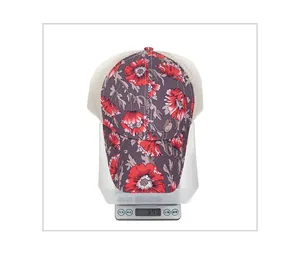 Floral print baseball cap on digital scale showing a weight of 64.9 grams clearly