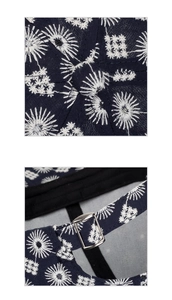 Close-up of the adjustable metal buckle and floral embroidery on the navy baseball cap