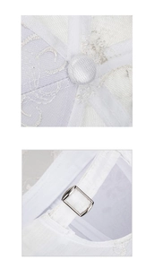 Close-up of white lace baseball cap featuring detailed embroidery and adjustable metal buckle