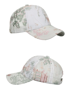Detailed side view showing delicate floral and landscape embroidery on this beige baseball cap
