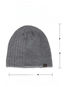 Detailed view of gray knit beanie with 100% acrylic material tag and size measurements