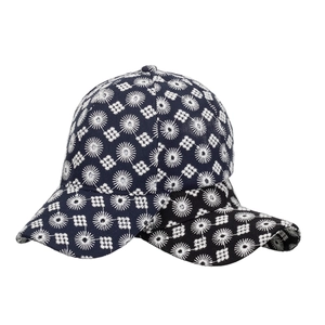 Navy blue baseball cap with white floral embroidery and geometric patterns on white background