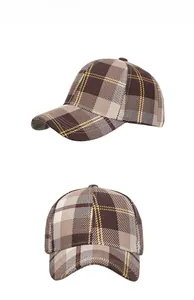Detail of British plaid baseball cap with thick twill fabric and yellow stitching