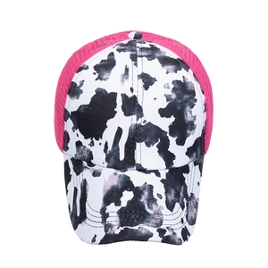 Women's ponytail baseball cap with cow print pattern and pink mesh back design