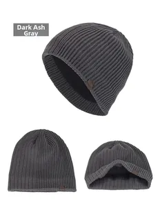 Detail view of dark heather grey knitted beanie with warm fleece lining and leather tag