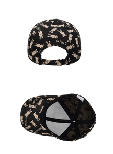 Detail of adjustable metal buckle and interior stitch construction on black rabbit print cap