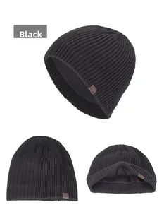 Close-up detail of black knitted winter hat showing thick texture and warm fleece lining