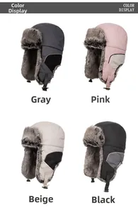 Detail view of winter earflap trapper hats in gray pink beige and black color options