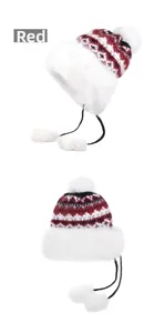 Detail of red Nordic winter hat with faux fur trim and large white pom-poms