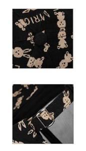 Detail of black jacquard baseball cap showing rabbit pattern and silver metal buckle