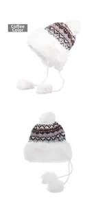 Detailed view of coffee checkered knit winter hat with white faux fur trim and pom-poms