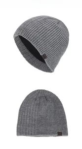 Detailed view of the thick knit texture and warm fleece lining of the grey beanie