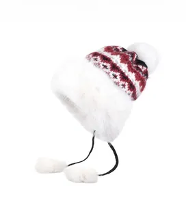Close-up of winter trapper hat with red plaid pattern and white faux fur lining details