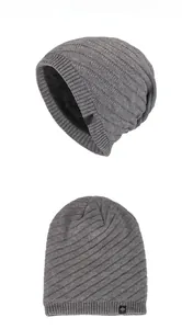 Detailed view of dark grey twill knit beanie with soft black fleece lining and snowflake tag