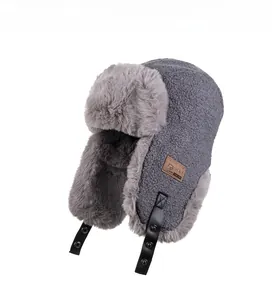 Close-up of grey aviator hat featuring thick faux fur lining and plush fleece exterior