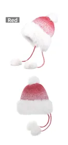 Detailed knit texture of red gradient winter trapper hat with white faux fur and pom-poms