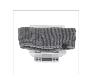 Detailed top view of grey ribbed knit headband being weighed on a white digital scale