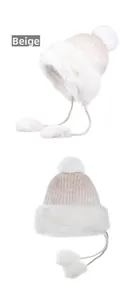 Detail of beige winter trapper hat with white faux fur lining and large fluffy pom-poms