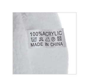 Detailed view of the 100% acrylic material tag and care labels on the plush winter hat