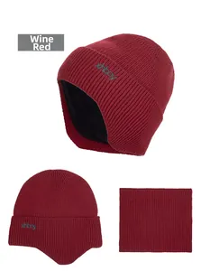 Detail of wine red knit beanie and neck gaiter set with thick fleece lining