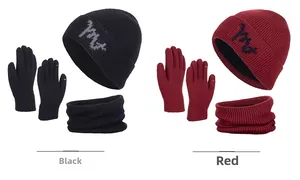 Close-up of winter knit set including beanie, scarf, and gloves in black and burgundy colors