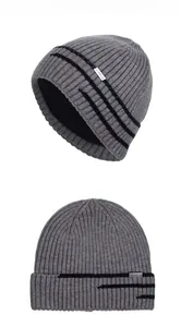 Détail d'un bonnet en tricot gris avec doublure polaire épaisse et rayures noires
