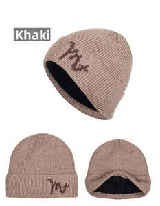 Close-up of khaki ribbed knit beanie with warm fleece lining and m+ embroidered patch