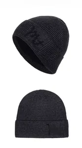 Close-up of knit texture and embroidered logo on warm grey winter beanie