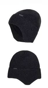Detailed close-up of a black ribbed knit beanie with warm fleece lining and metal logo tag