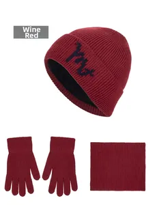 Three-piece winter set in wine red featuring knitted hat, gloves, and neck warmer
