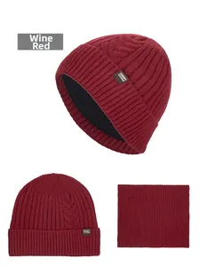 Detail of wine red cable knit beanie and matching neck warmer set with leather patch