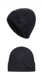 Detail shot of black ribbed knit beanie featuring premium embroidery and soft fleece lining