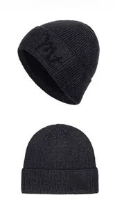 Detailed view of black ribbed knit beanie showing high-density fabric and embroidery