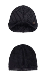 Detail of dark grey cable knit beanie with thick fleece lining and leather brand patch