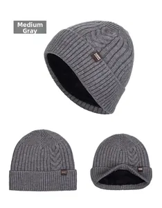 Detail view of medium heather gray knit beanie with thick fleece lining and leather label