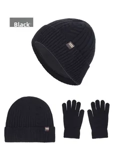 Detail of black winter knitted beanie and gloves set with warm fleece lining and leather logo