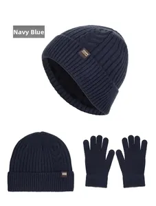 Detail of navy blue ribbed knit beanie and gloves set with a brown leather patch