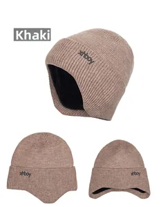 Detail view of khaki knit hat showing thick ribbed texture and warm black fleece lining