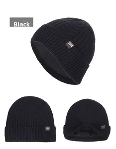 Close-up of black cable knit beanie featuring thick fleece lining and leather brand patch