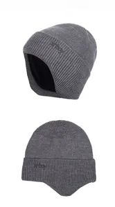 Close-up of dark grey thermal knitted beanie featuring ear protection and warm fleece lining