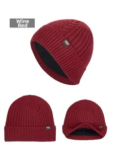 Detailed view of wine red knit beanie featuring a fleece lining and metal logo plate