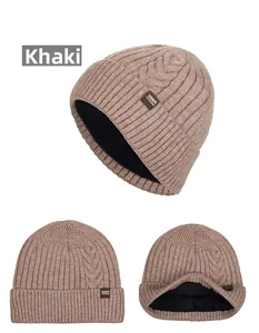 Detail of khaki cable knit beanie featuring thick fleece lining and XHBOY leather patch
