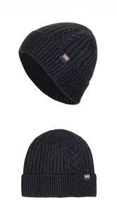 Close-up of charcoal knitted beanie featuring cable patterns and warm fleece lining