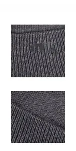 Detailed macro view of dark grey winter beanie with xhboy embroidery and ribbed knit texture