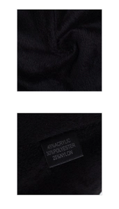 Close-up of black fuzzy thermal lining fabric and material composition label on winter hat