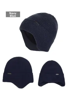 Detail view of navy blue ribbed knit beanie featuring warm ear flaps and metal logo tag
