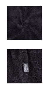 Detail of winter beanie fabric showing material label with acrylic and polyester fibers