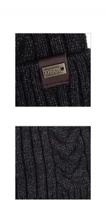 Macro shot of dark grey knit texture with ribbed patterns and metal XHBOY logo plaque