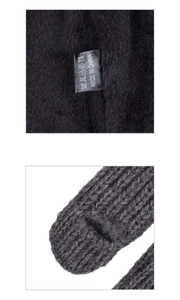 Detail view of black faux fur lining and grey thick knit fabric with care label