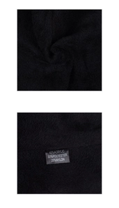 Detail showing the composition label of the warm knitted beanie with acrylic and nylon blend